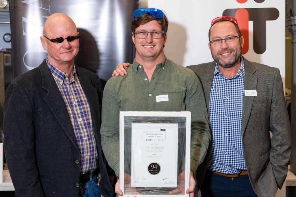 544efadc-e0b1-b03f-e121-a7323b3d4b32 Bobby receiving his award, joined by Christian Eedes of WineMag (left) and Tiaan Erasmus of iTOO Special Risks (right).